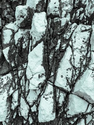 Detailed texture of white limestone rock formations in Poreč, Croatia, emphasizing nature's patterns.