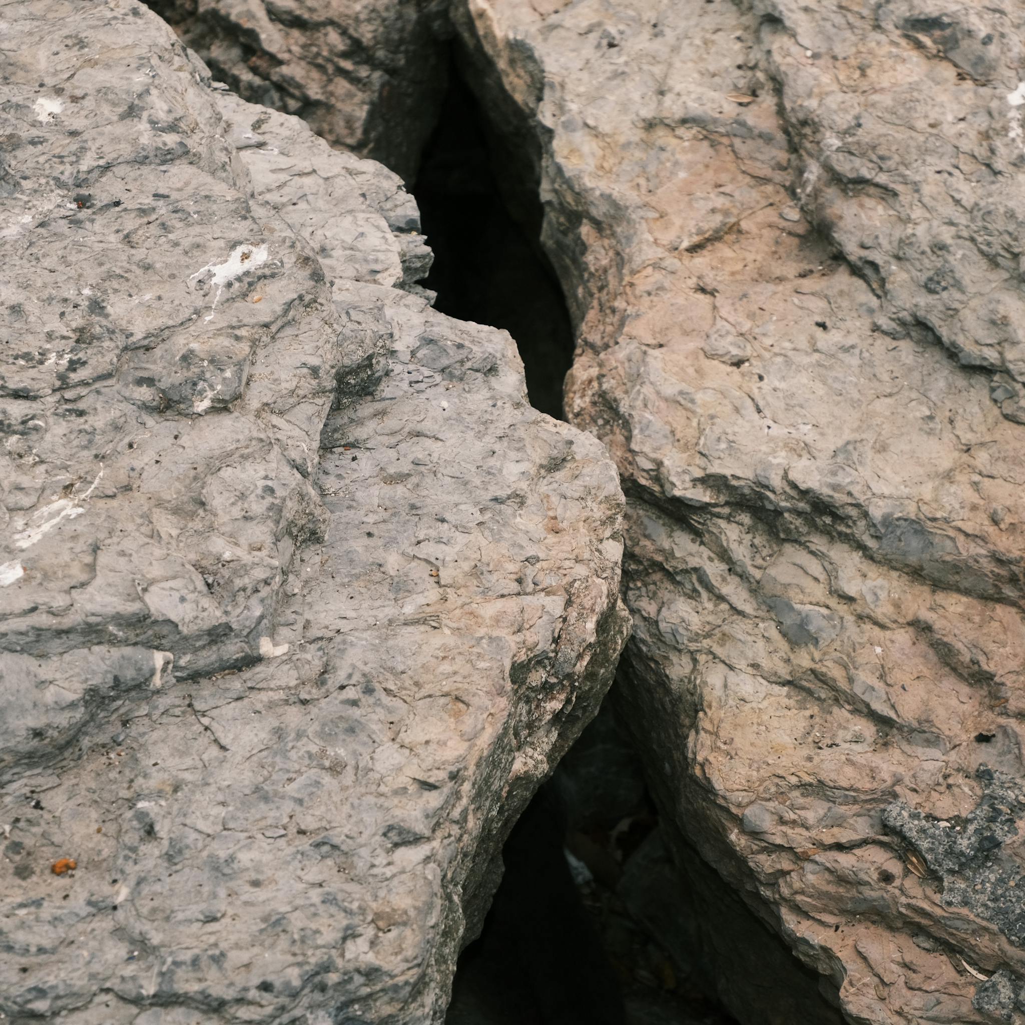 Detailed view of rugged rock formation with visible layers and textures, suitable for geology themes.